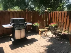 A SHADY BBQ PATION WITH TABLE FOR  SIX